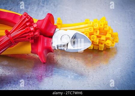 Nippers plastic tying cables on scratched metallic background Stock Photo
