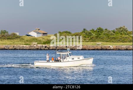 small fishing vessel ila anne returning to Montauk Harbor Stock Photo