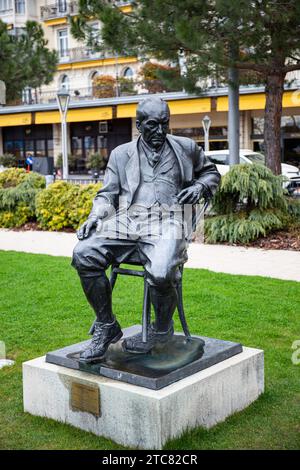 Montreux, Switzerland - March 31, 2018: Bronze statue of Vladimir Nabokov in Montreux garden. He sitting on the chair. Stock Photo