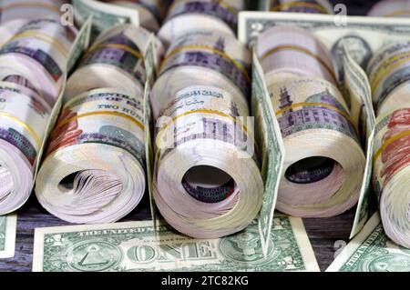 Piles and bundles of Egypt money  thousands of Pounds currency banknotes bills rolls of 200 EGP LE, Egyptian money exchange rate and USA American doll Stock Photo