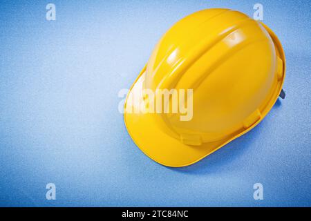 Hard hat on blue background construction concept Stock Photo
