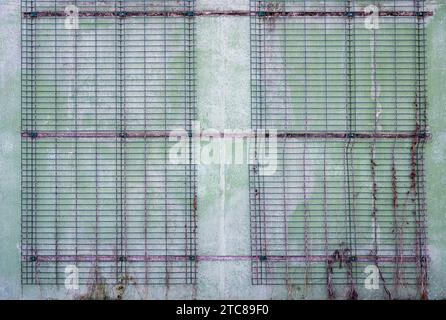 Grimbergen, Flemish Brabant Region, Belgium, November 28, 2023 - Metal grid patterns against a worn concrete wall Credit: Imago/Alamy Live News Stock Photo