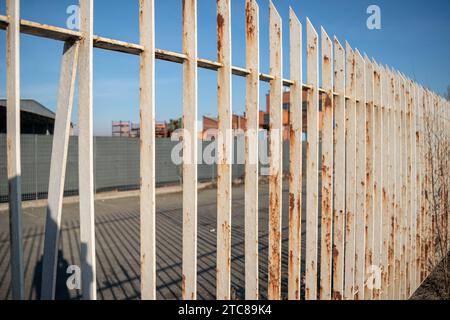 rusty gate, border of different states with steel elements. It is forbidden to cross the grates of a gate to avoid the risk of violating the property Stock Photo