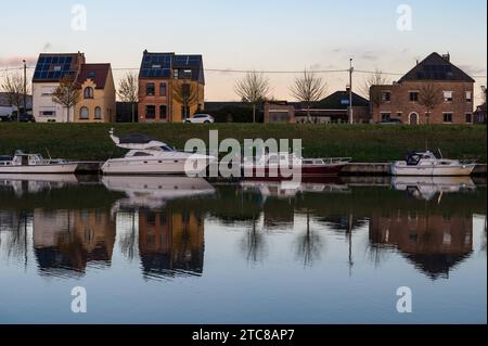 Grimbergen, Flemish Brabant Region, Belgium, November 28, 2023 - Residential houses in a row and boats reflecting in the water of the canal at dusk Credit: Imago/Alamy Live News Stock Photo