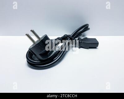 The PC and PSU power cables are black on white background isolated Stock Photo