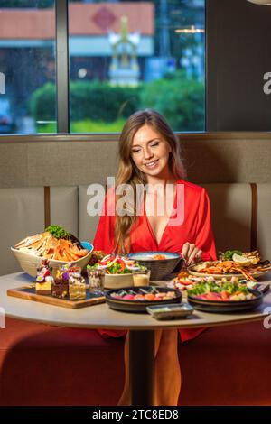 Elegant woman enjoys gourmet meal at restaurant. Dining and cuisine experience. Stock Photo
