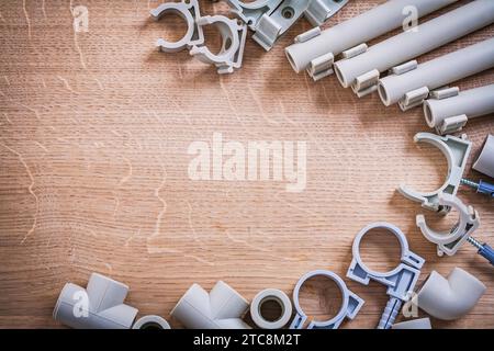 Organized Copyspace Big Set Polypropylene Fixators And Pipe With Clips Fittings On Wooden Board Stock Photo