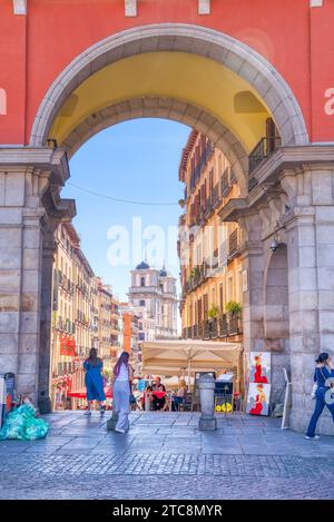 Madrid, Spain - August 28, 2023:  Exiting the historic Plaza Mayor on to the charming old streets of central Madrid Stock Photo