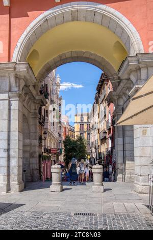 Madrid, Spain - August 28, 2023:  Exiting the historic Plaza Mayor on to the charming old streets of central Madrid Stock Photo