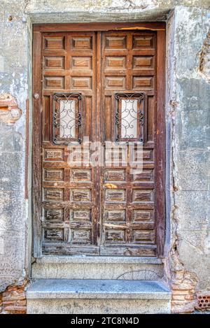 Old wooden weathered doorway in historic spain Stock Photo