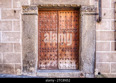 Old wooden weathered doorway in historic spain Stock Photo