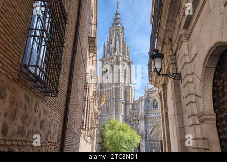 The 13th century Primatial Cathedral of Saint Mary of Toledo appears through the streets in historic Toledo, Spain Stock Photo