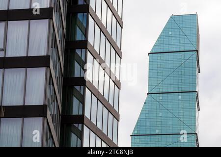 Tbilisi, Georgia - September 23, 2023: glass tower of The Biltmore Hotel, skyscrapers in Tbilisi city on overcast autumn day Stock Photo