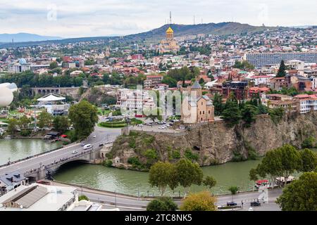 Tbilisi, Georgia - September 23, 2023: above view of Tbilisi city with Metekhi from Narikala fortress on cloudy autumn day Stock Photo