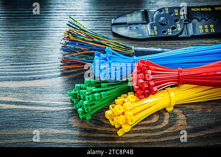 Electric wires tying cables bolt cutter on wooden board Stock Photo