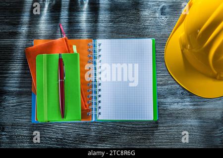 Square notebooks pen safety cap on wooden board Stock Photo