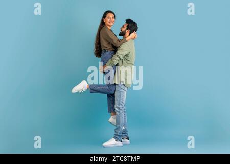 Loving indian guy lifting up his beautiful girlfriend Stock Photo