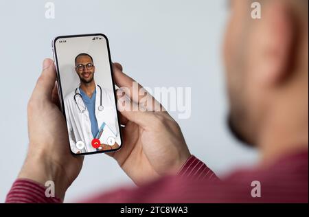 Telemedicine Concept. Closeup Of Man Having Video Call With Doctor On Smartphone Stock Photo