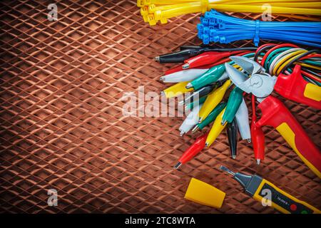 Insulating wire cutter for tying cables Electrical tester Crocodile plug on dielectric cover Stock Photo