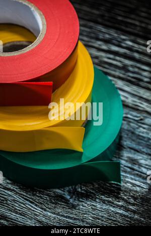 Insulating tapes on old wooden board Stock Photo