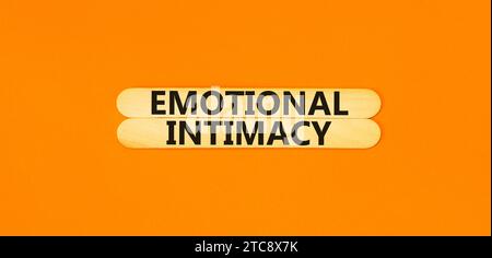 Emotional intimacy symbol. Concept words Emotional intimacy on beautiful wooden stick. Beautiful orange table orange background. Psychology emotional Stock Photo