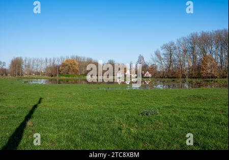 Flooded meadows with houses reflecting in the water,  Imde, Meise, Belgium Stock Photo