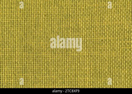 A green woven fabric texture. The image is a full frame of the fabric with a slight variation in the color and texture Stock Photo
