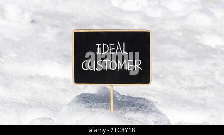 Ideal customer symbol. Concept words Ideal customer on beautiful black chalk blackboard. Chalkboard. Beautiful snow background. Business ideal custome Stock Photo