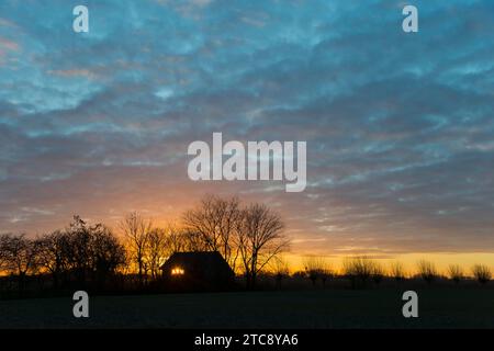 Sunset, sky burning, evening sun shining through a window of a house, house on the Dijkweg, Holwierde, Eemsdelta, Groningen, Netherlands Stock Photo