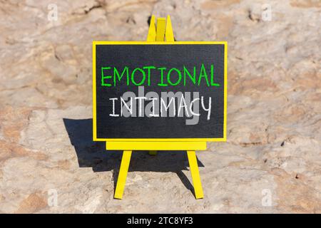 Emotional intimacy symbol. Concept words Emotional intimacy on beautiful black chalk blackboard. Beautiful red stone background. Psychology emotional Stock Photo