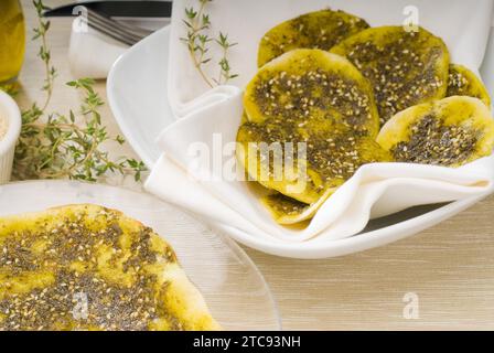 Lebanese manouche or manoushe, lebanese pizza with thyme and sesame seeds, zaatar, and extra virgin olive oil on top Stock Photo