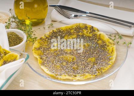 Lebanese manouche or manoushe, lebanese pizza with thyme and sesame seeds, zaatar, and extra virgin olive oil on top Stock Photo