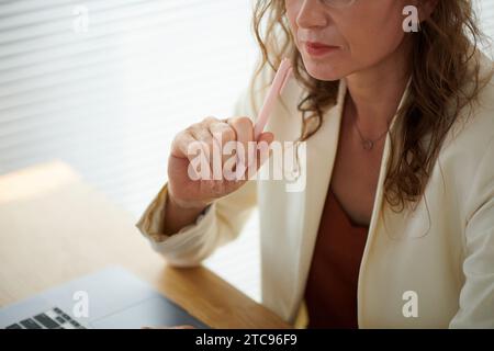 Pensive mature female entrepreneur working on business plan Stock Photo