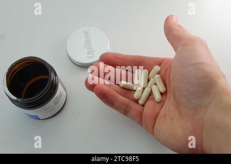 Dublin, Ireland - December 13th 2023: A photo of medical probiotic tablets and its container and lid on a white background. Stock Photo