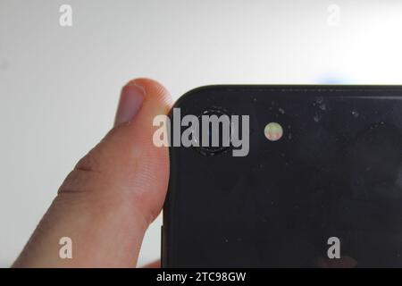 A close up photo of the camera on the outside of a black iPhone 8. Stock Photo