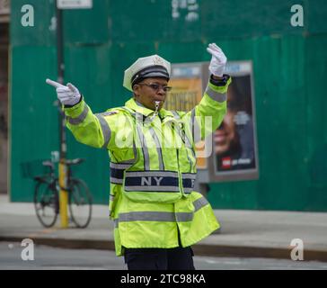 Traffic cop directing traffic at an intersection in lower Manhattan Stock Photo