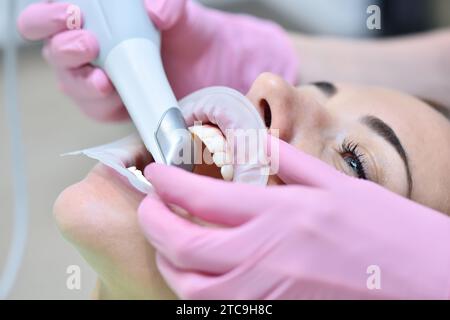 Orthodontist scaning patient with dental intraoral scanner. Prosthodontics And Stomatology Concept. Close Up Stock Photo