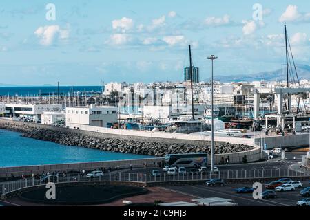 Lanzarote, Spain - November 25, 2023: View of boats in Baha de Arrecife Marina surrounded by shops, bars and restaurants at sunset, Arrecife, Lanzarot Stock Photo