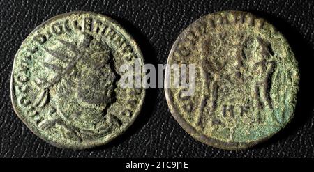 Ancient Roman coin of Emperor Diocletian, top view of old metal money isolated on black background. Theme of vintage copper or bronze texture, Rome, E Stock Photo