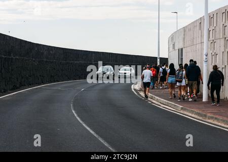 Lanzarote, Spain - November 25, 2023: Tourists walking towards the town centre in Arrecife de Lanzarote, Spain Stock Photo