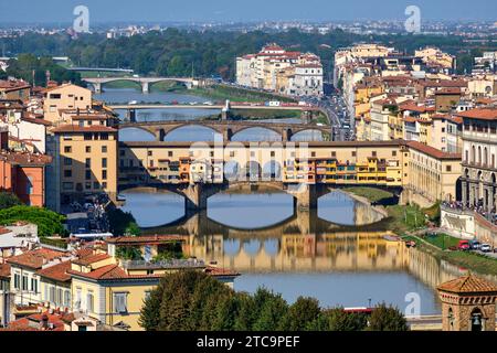 An aerial view taken from the Piazzale Michelangelo of the Ponte Vecchio with its colorful stores spanning the Arno river on a bright sunny day in Flo Stock Photo