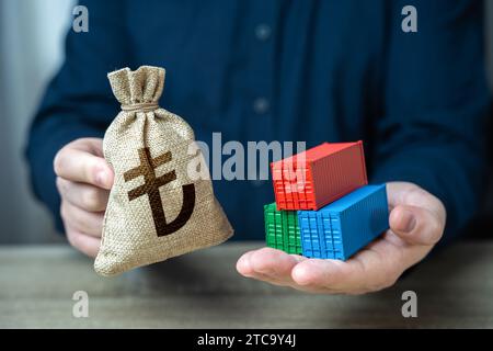 Shipping containers and turkish lira money bag. Import and export. Profit from sales of goods. Economic growth, increased production and development o Stock Photo