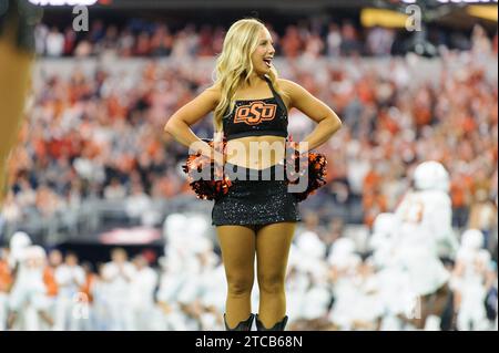 Arlington, Texas, USA. 2nd Dec, 2023. Oklahoma State Cowboys cheerleader before the NCAA Football game between the Oklahoma State Cowboys and Texas Longhorns at AT&T Stadium in Arlington, Texas. Matthew Lynch/CSM/Alamy Live News Stock Photo