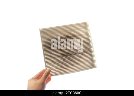 Car air conditioner filter isolated , filter clogged and dirty in a hand on white background include clipping path , Car spare parts concept Stock Photo