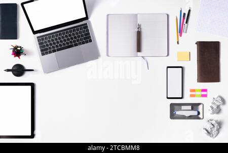 Laptops and stationery for work on the desk are arranged (blank screen and blank space) Stock Photo