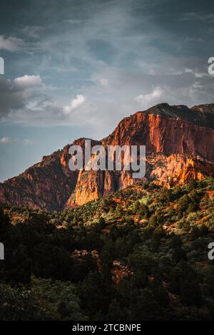 A scenic landscape view of mountains with sunlight streaming through the trees in the United States Stock Photo