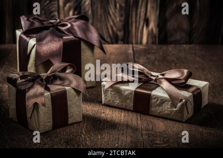 Gift boxes with brown bows on a vintage wood background Stock Photo