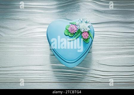 Blue heart-shaped gift box on wooden board holiday concept Stock Photo