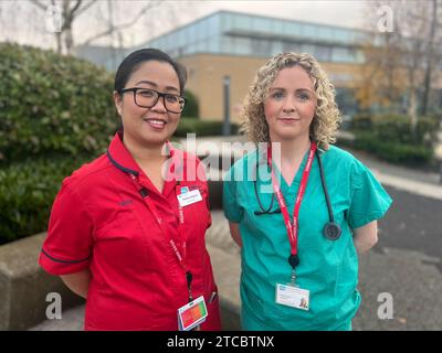 Doctor Eimhear Kearney (right) and nurse Almira Barro outside Antrim Area Hospital. Healthcare staff have said they are being verbally or physically attacked on a daily basis, as new figures from the Department of Health show there have been more than 50,000 attacks in the last five years. The figures were released by the department as it launches a new framework to help tackle violence and aggression towards health and social care (HSC) staff. Picture date: Monday December 11, 2023. Stock Photo