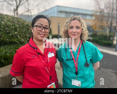 Doctor Eimhear Kearney (right) and nurse Almira Barro outside Antrim Area Hospital. Healthcare staff have said they are being verbally or physically attacked on a daily basis, as new figures from the Department of Health show there have been more than 50,000 attacks in the last five years. The figures were released by the department as it launches a new framework to help tackle violence and aggression towards health and social care (HSC) staff. Picture date: Monday December 11, 2023. Stock Photo